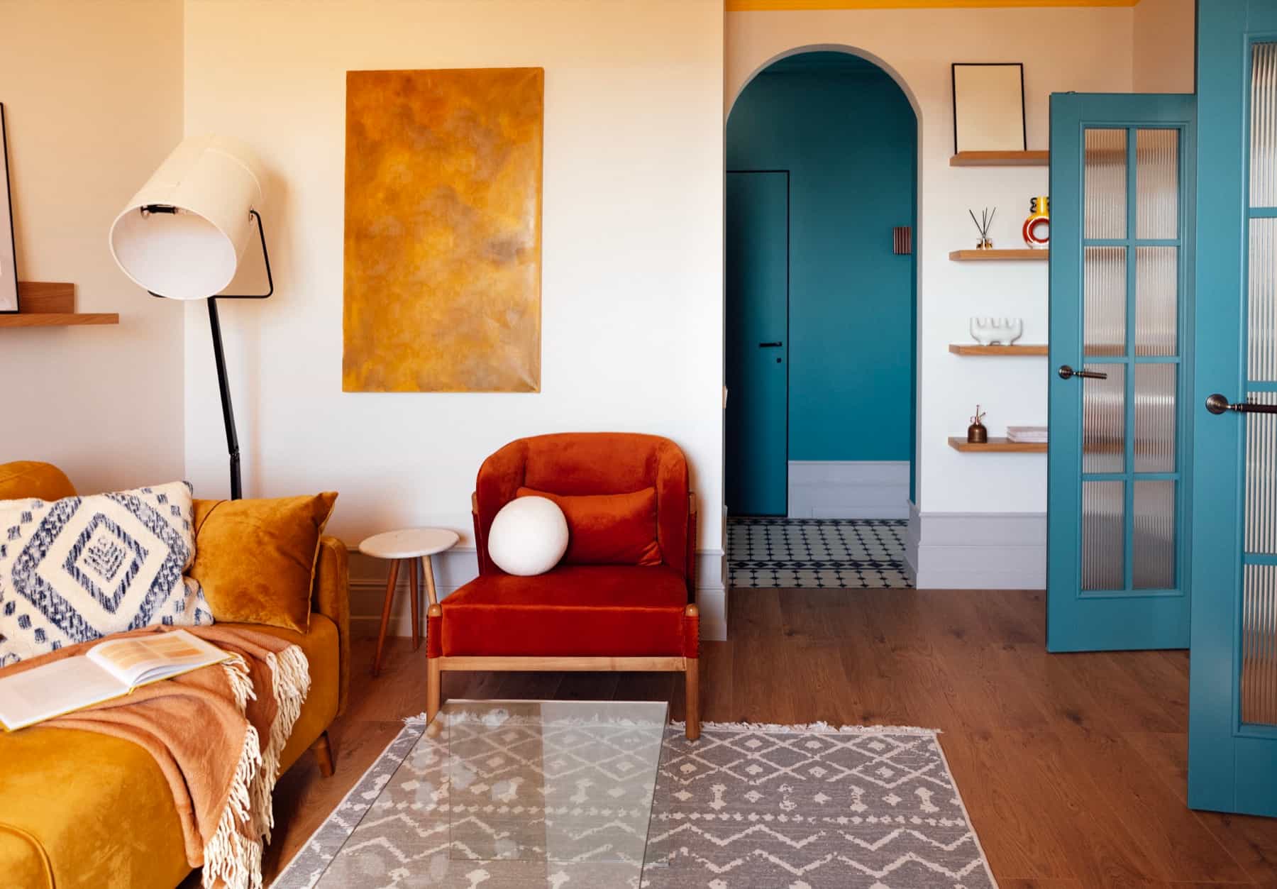Bright rental living room with an orange armchair