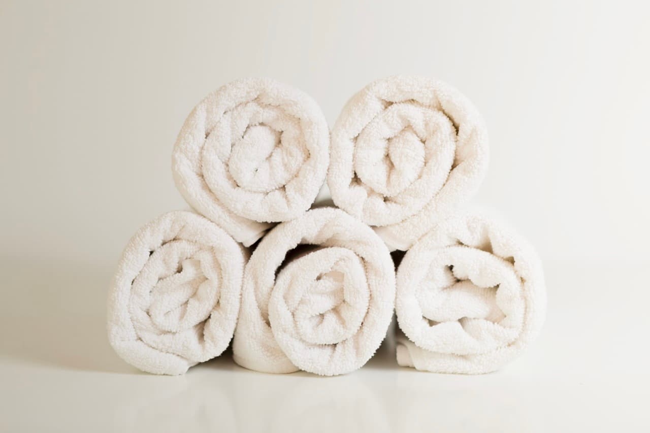 Rolled white towels stacked in a pyramid