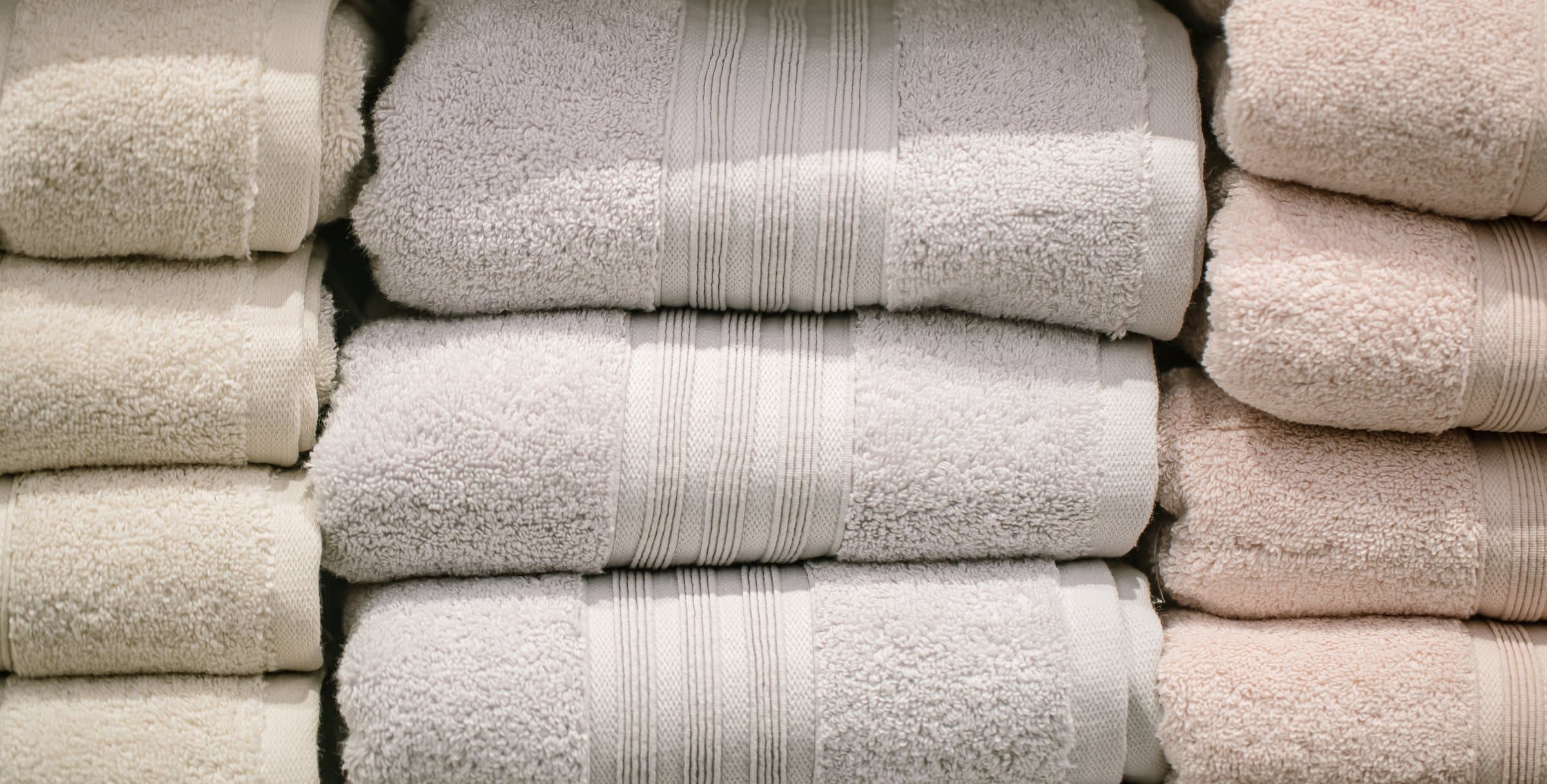 Stacks of folded white and cream towels